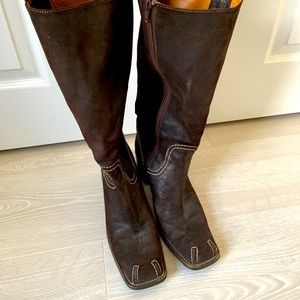 Brown leather boots with stitching detail.